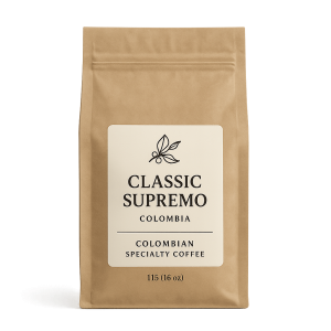 A close-up studio shot of a brown paper coffee bag with a white label displaying the text "CLASSIC SUPREMO COLOMBIA COLOMBIAN SPECIALTY COFFEE 115 (16 oz)".